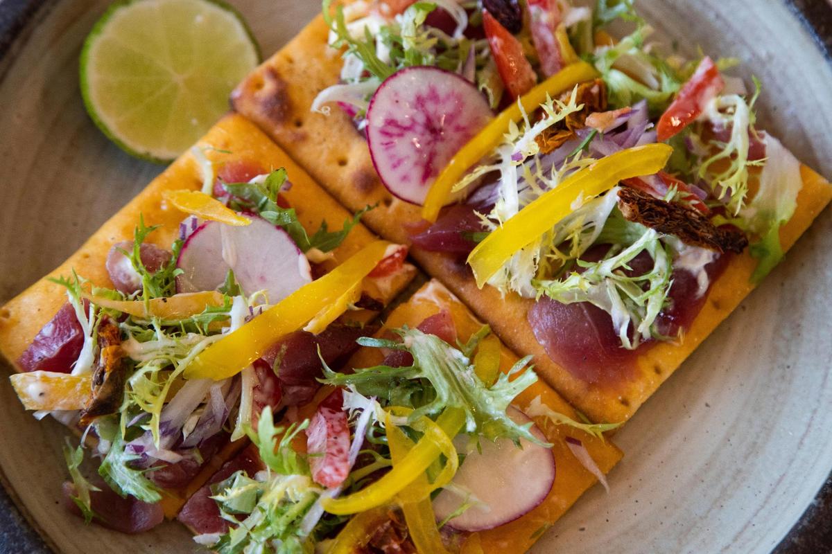 The New Style Tuna Pizza, with radishes, tuna, frisée, bell peppers and truffle oil on a sweet potato flat bread at M Grille on Friday, March 26, 2021. The restaurant was closed for three years.