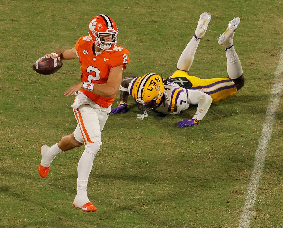 Clemson quarterback Cade Klubnik (2) scrambles away from LSU linebacker Harold Perkins Jr. (7) on Saturday.
