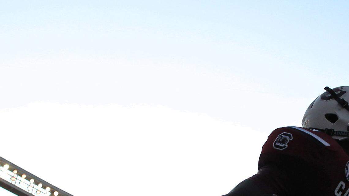 South Carolinas' Sharrod Golightly (9) and Victor Hampton, right, enter the field to 2001 before the start of the North Carolina game on Thursday, Aug. 29, 2013 in Columbia, S.C.