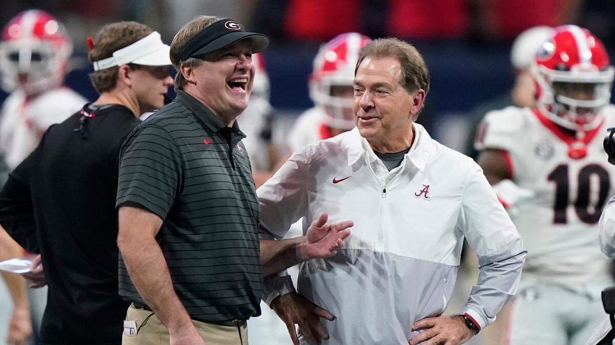 FILE - Georgia head coach Kirby Smart speaks with Alabama head coach Nick Saban before the first half of the Southeastern Conference championship NCAA college football game, Saturday, Dec. 4, 2021, in Atlanta. Georgia plays Alabama in the College Football Playoff national championship game on Jan. 10, 2022. (AP Photo/Brynn Anderson, File)