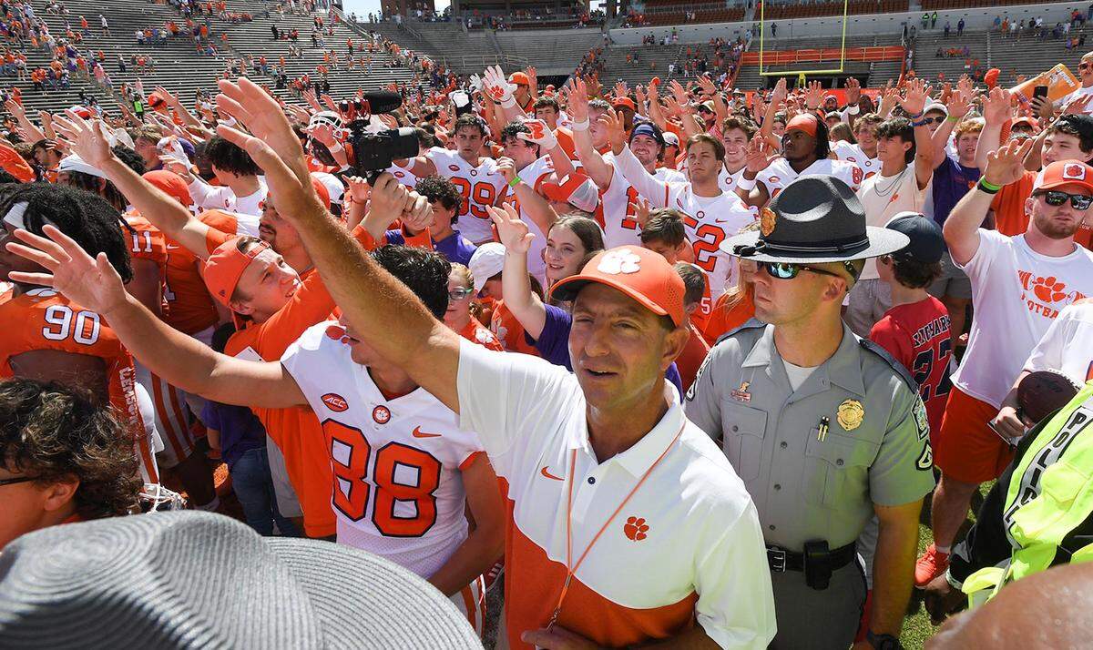 Clemson head coach Dabo Swinney joins alma mater with team and fans after the annual Orange and White Spring game at Memorial Stadium on April 15.