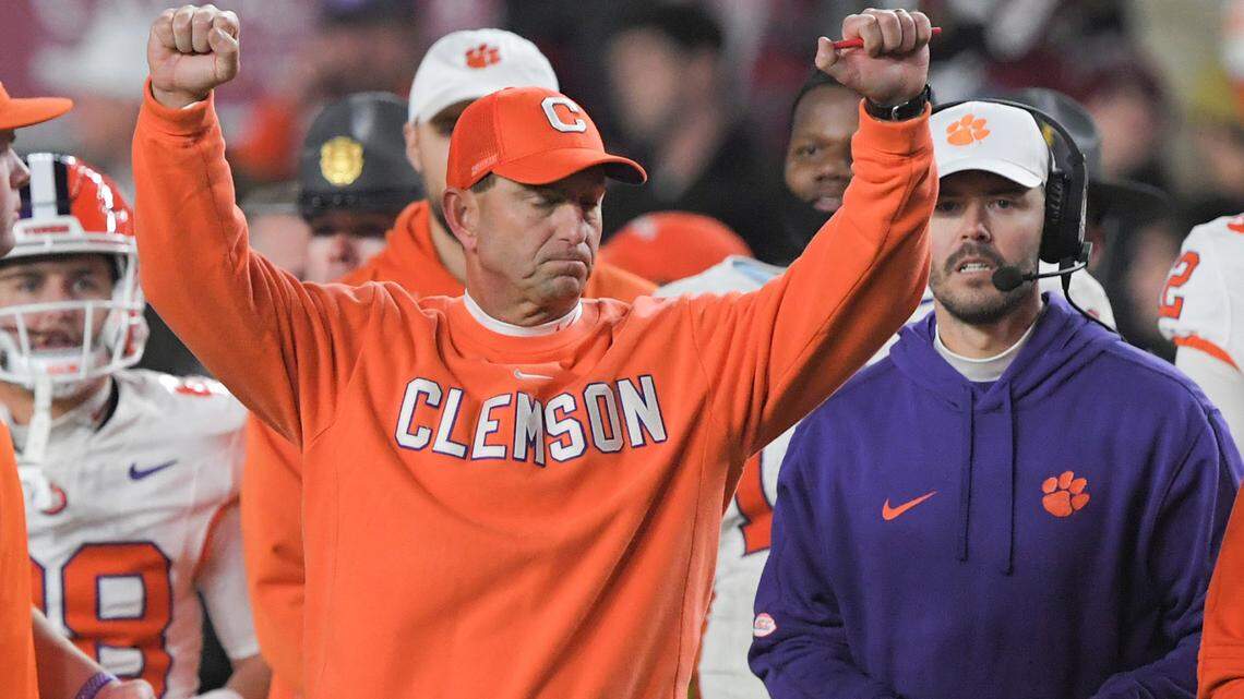 Nov 25, 2023; Columbia, South Carolina, USA; Clemson Tigers head coach Dabo Swinney celebrates with offensive coordinator Garrett Riley as time expires against the South Carolina Gamecocks at Williams-Brice Stadium. Clemson won 16-7.