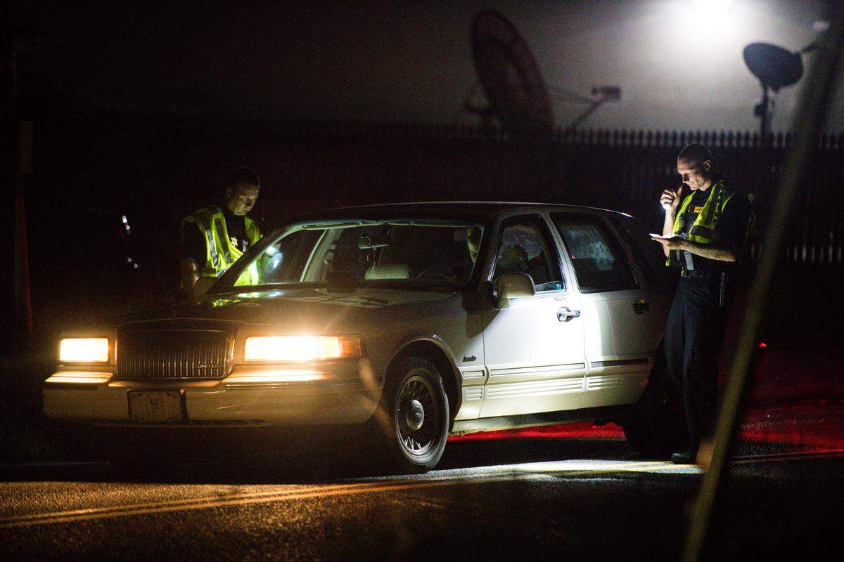 Members of law enforcement conduct a safety check on Friday night, Aug. 17, 2018, near Camden, S.C. 