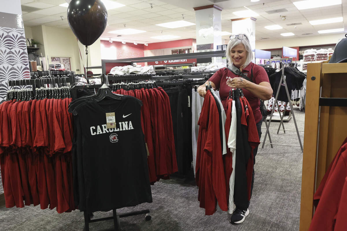 Jessica Koumas sorts through new, Nike Gamecock shirts for her three sons and two grandsons at the USC Campus Store at the Russell House on Wednesday, July 1, 2026.