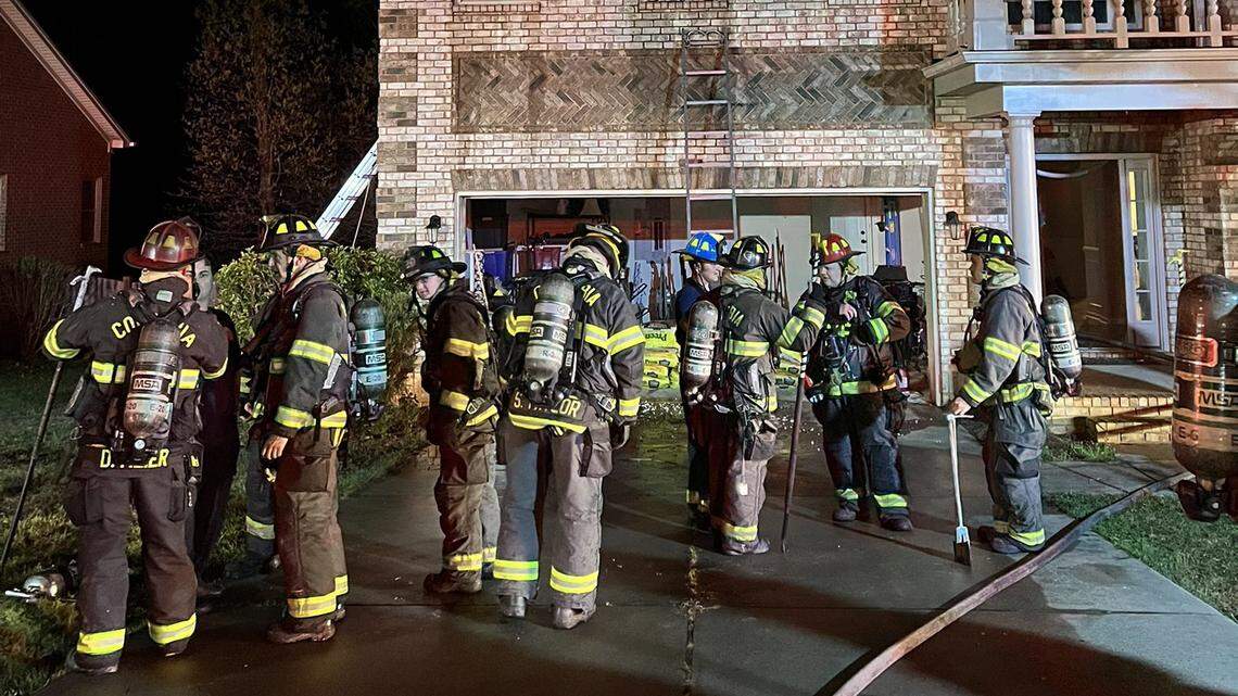 Fire fighters outside of home.
