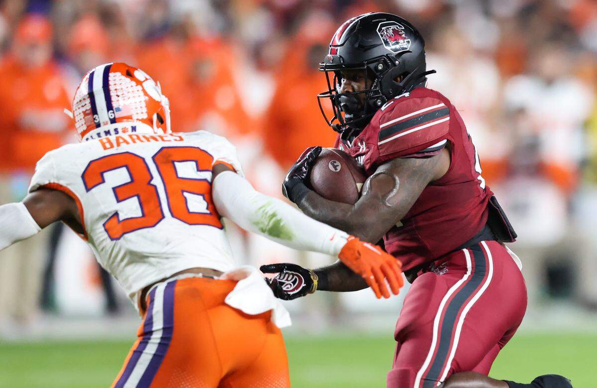 South Carolina running back Mario Anderson (24) is chased down by Clemson safety Khalil Barnes (36) during the first half of South Carolina’s game against Clemson at Williams-Brice Stadium in Columbia on Saturday, November 25, 2023.