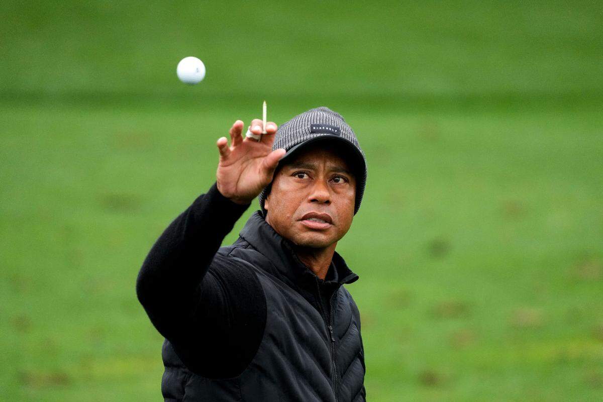 Tiger Woods tosses a ball on the driving range during the third round of The Masters golf tournament.