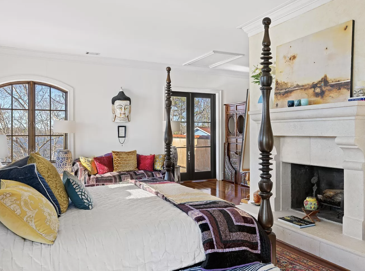 The house has two fireplaces including this one in the primary bedroom suite.