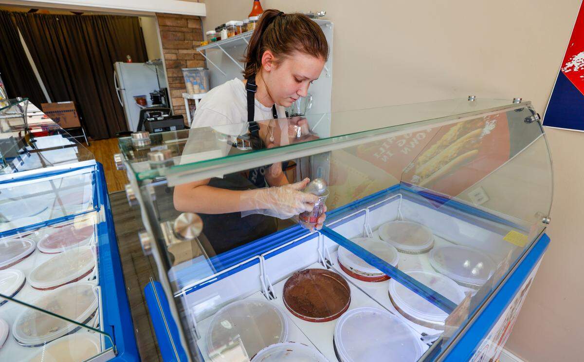 Taylor Christie scoops ice cream for a shake at IceCream Taco in Lexington. The new ice cream parlor and cafe in March.