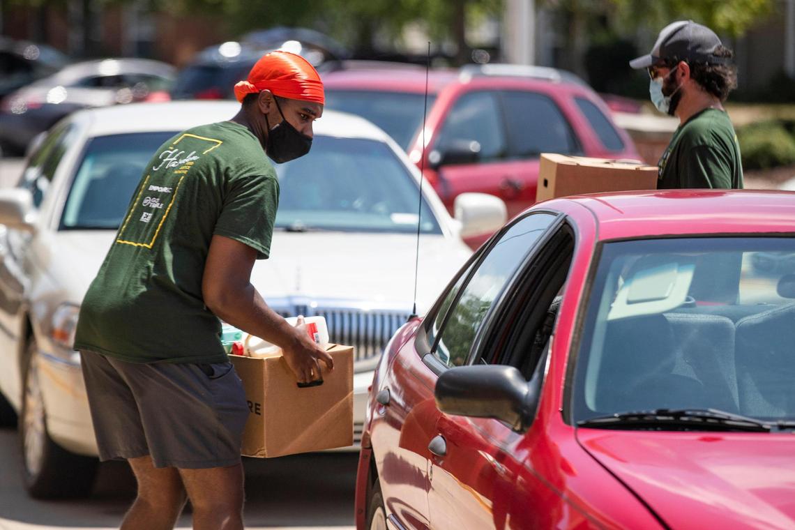Volunteers with the Harden Food Initiative, a program organized by Empower SC in partnership with other food and justice organizations in Columbia, hand out food at the Drew Wellness Center on Friday, July31, 2020. Empower SC wanted to feed families in the neighborhood near the closed Save-a-Lot grocery store on Harden Street, and bring attention to the needs going unmet in the neighborhood.