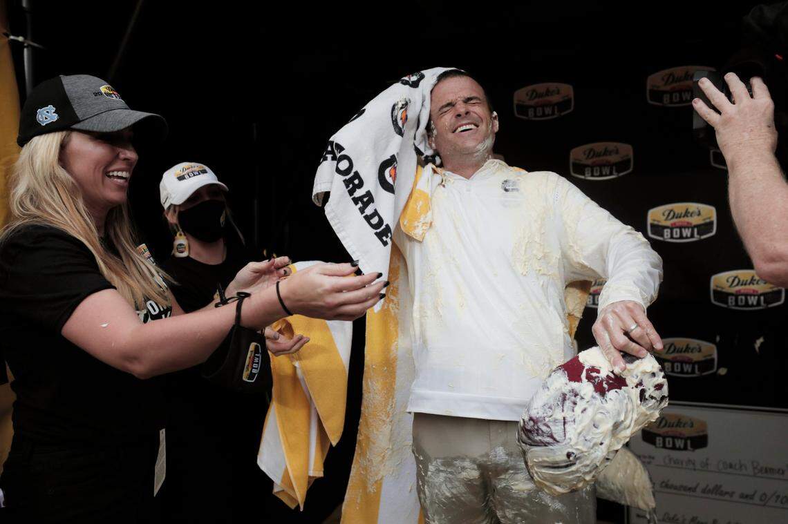 South Carolina Gamecocks head coach Shane Beamer whipes mayonnaise off himself after his team beat North Carolina at the Duke’s Mayo Bowl at Bank of America Stadium in Charlotte, North Carolina on Thursday, December 30, 2021.