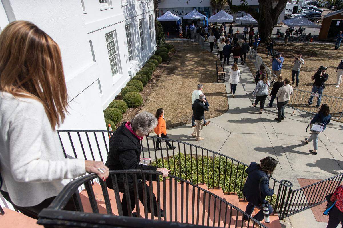 Press, attorneys and onlookers exit through the emergency doors of the Colleton County Courthouse after a bomb threat was made on Wednesday, Feb. 8, 2021.