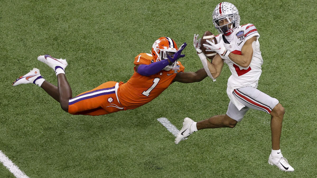 Ohio State wide receiver Chris Olave catches a touchdown pass with Clemson cornerback Derion Kendrick in coverage Friday night in the Sugar Bowl.