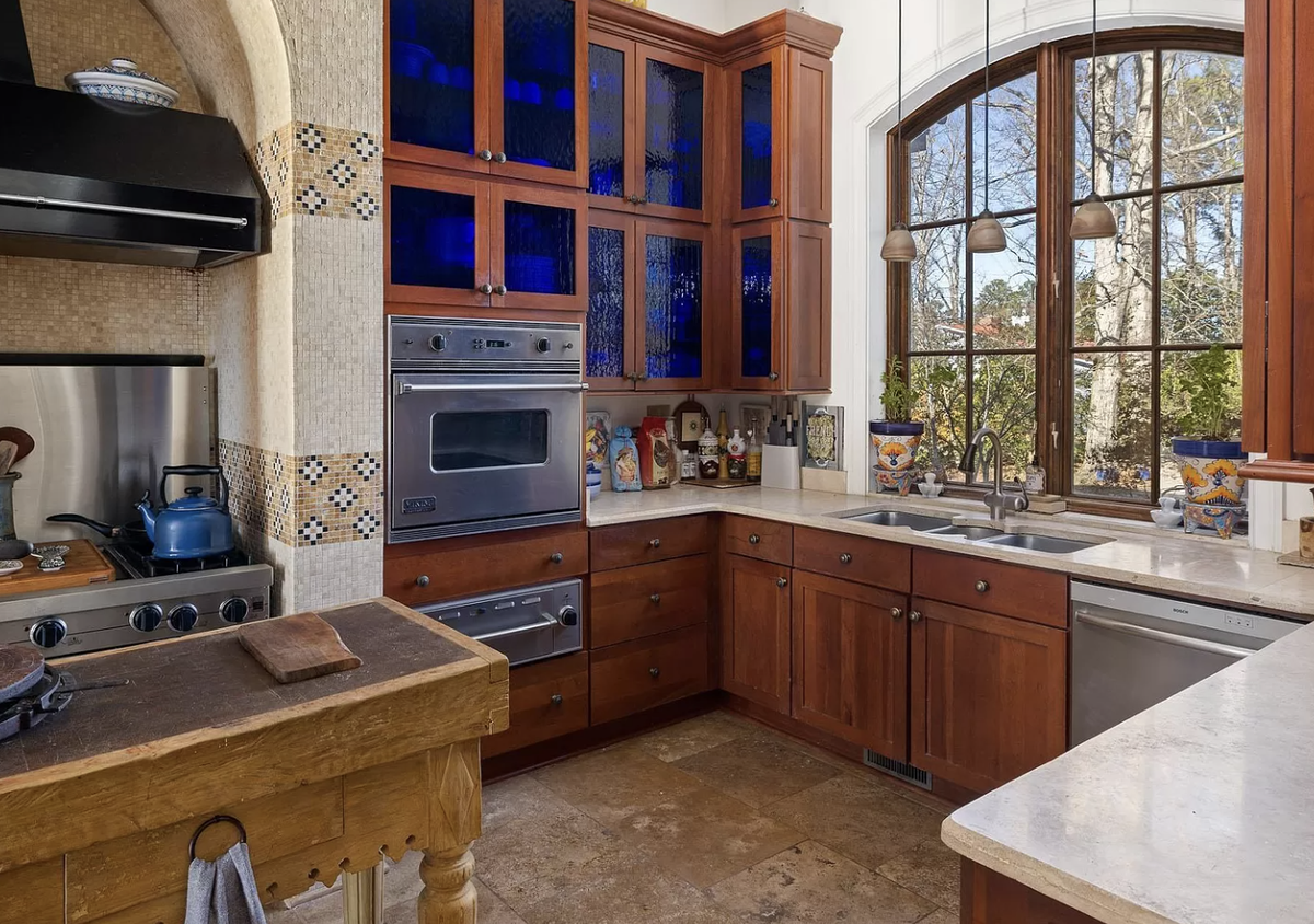 The kitchen has cherry cabinets with Moroccan cobalt blue stained water glass inlays..