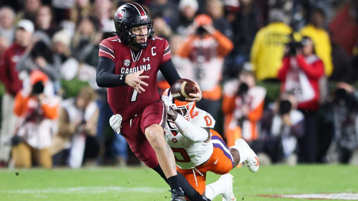 South Carolina quarterback Spencer Rattler (7) gets brought down by Clemson linebacker Barrett Carter (0) during the first half of South Carolina’s game against Clemson at Williams-Brice Stadium in Columbia on Saturday, November 25, 2023.