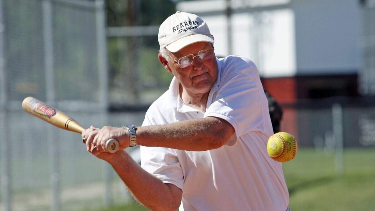 Brookland-Cayce softball head coach Richard Lundy hits ground balls during practice in 2007.
