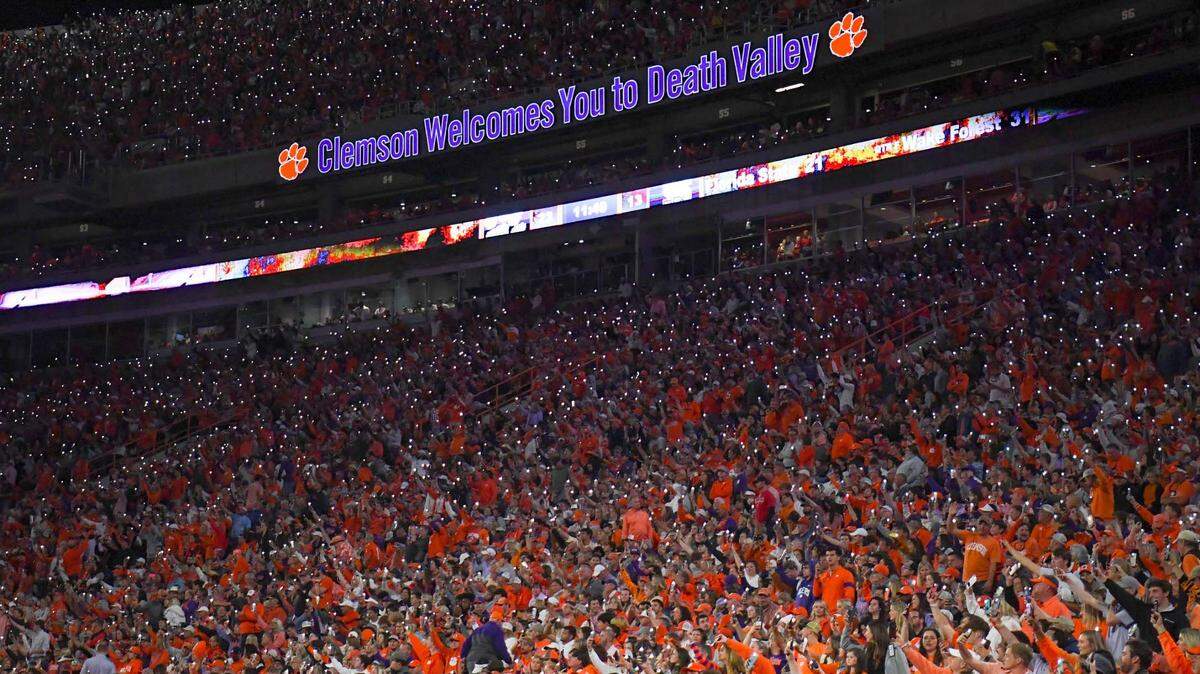 Fans use their cell phones to light up a darkened stadium, before the start of the fourth quarter at Memorial Stadium in Clemson, South Carolina Saturday, October 1, 2022.