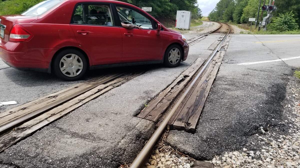 A car bumps across the rugged railroad crossing in the 1700 block of S. Beltline Boulevard in Columbia. CSX says it will repair the crossing this summer.