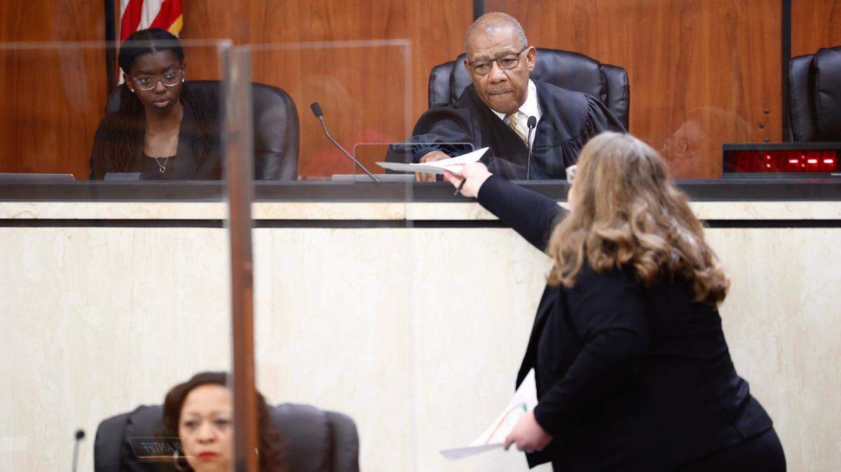 Kathleen McDaniel, a lawyer for Planned Parenthood, hands documents to Judge Clifton Newman on Friday, May 26, 2023, in the Richland County Courthouse in Columbia, S.C. Planned Parenthood South Atlantic, the Greenville Women’s Clinic and two doctors have sued over South Carolina’s new six-week abortion law.