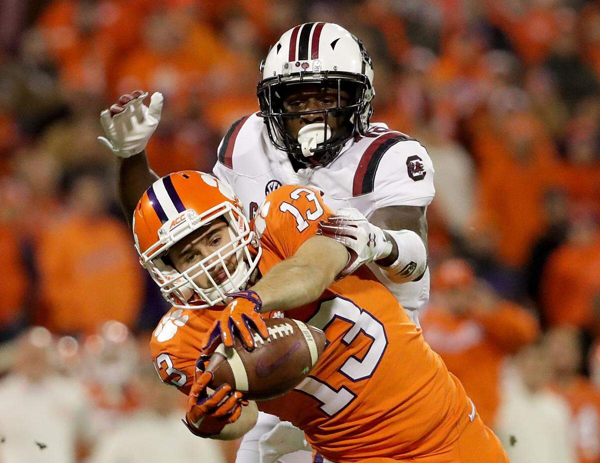 Hunter Renfrow #13 of the Clemson Tigers makes a catch against Rashad Fenton #16 of the South Carolina Gamecocks during their game at Clemson Memorial Stadium on November 24, 2018 in Clemson, South Carolina.