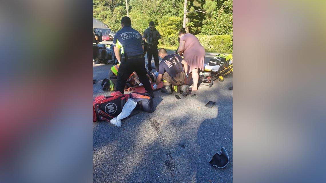 Medics gather around an injured South Carolina motorcyclist in a 2021 crash where an Amazon truck driver allegedly distracted by watching porn video caused the accident