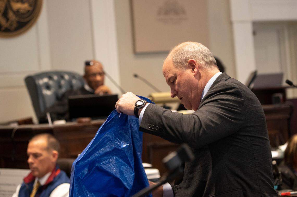 Defense attorney Jim Griffin unfolds a blue tarp to show to Mushelle “Shelly” Smith in the double murder trial of Alex Murdaugh at the Colleton County Courthouse in Walterboro, Monday, Feb. 6, 2023. Andrew J. Whitaker/The Post and Courier/Pool