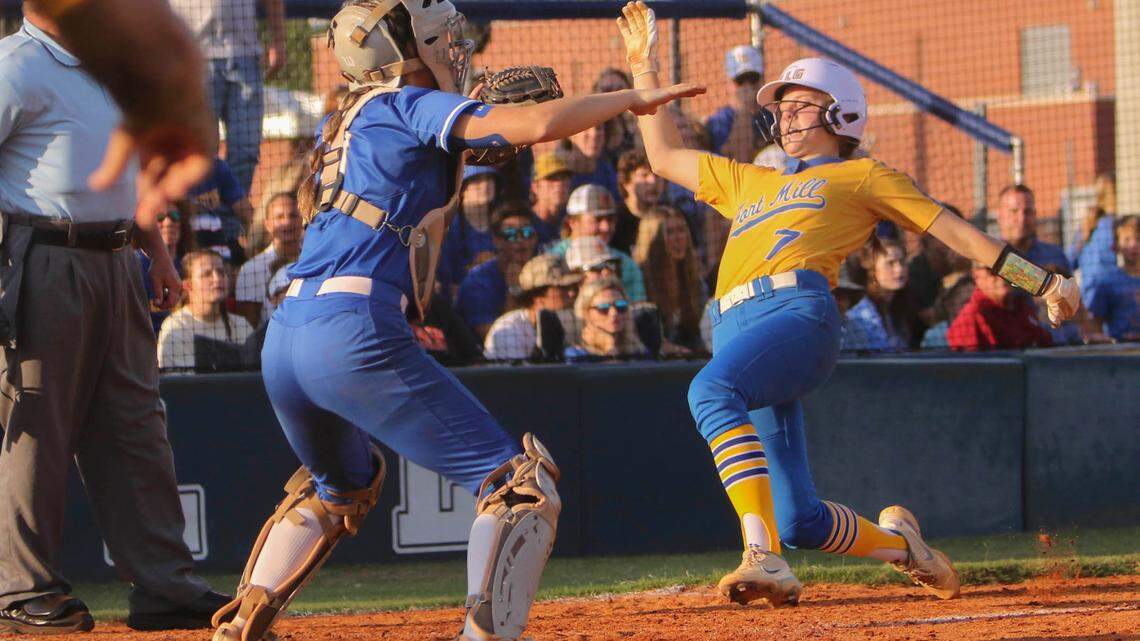 Fort Mill’s Maddie Drerup (7) scores as Lexington’s catcher Sarah Gordon (9) waits for the throw during the class 5A softball championship at Blythewood High on Friday, May 27, 2022.