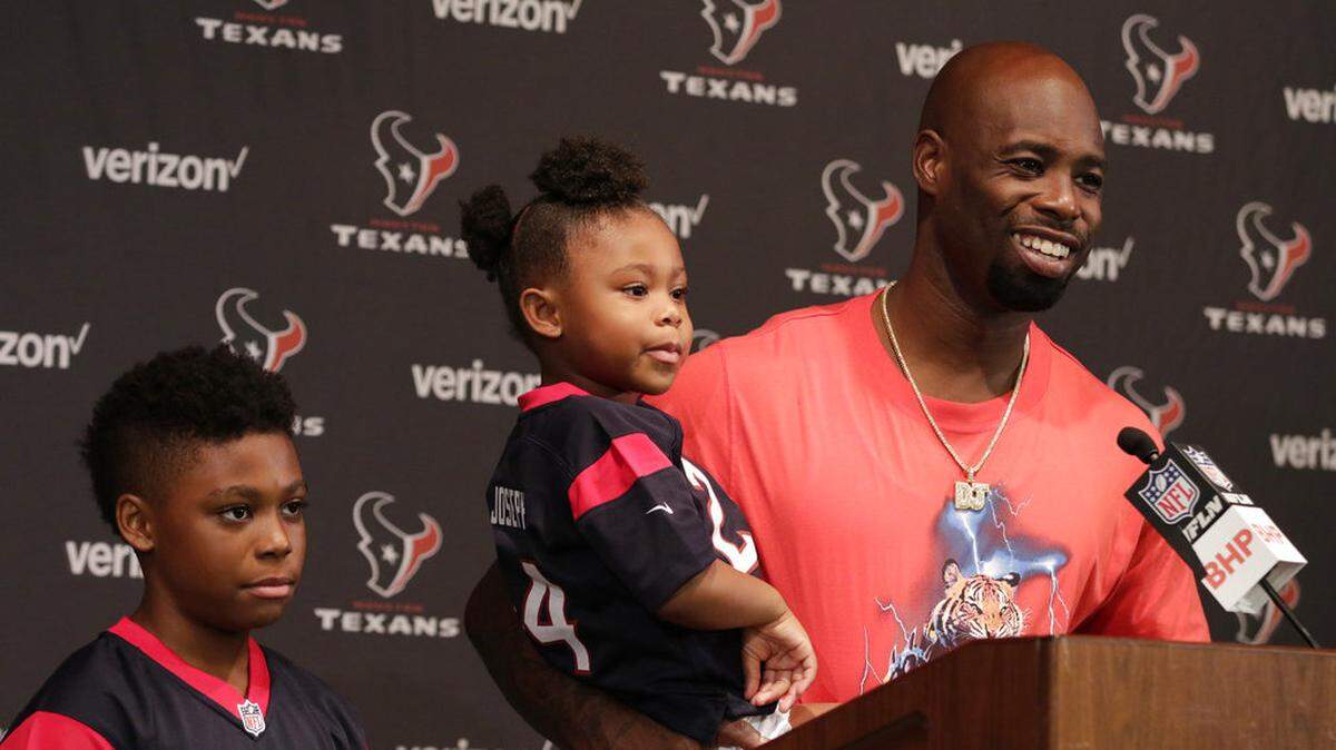 Houston Texans cornerback Johnathan Joseph, with his daughter Janae and son Jonathan Jr., talks with the media following an NFL football game against the Buffalo Bills, Sunday, Oct. 14, 2018, in Houston.