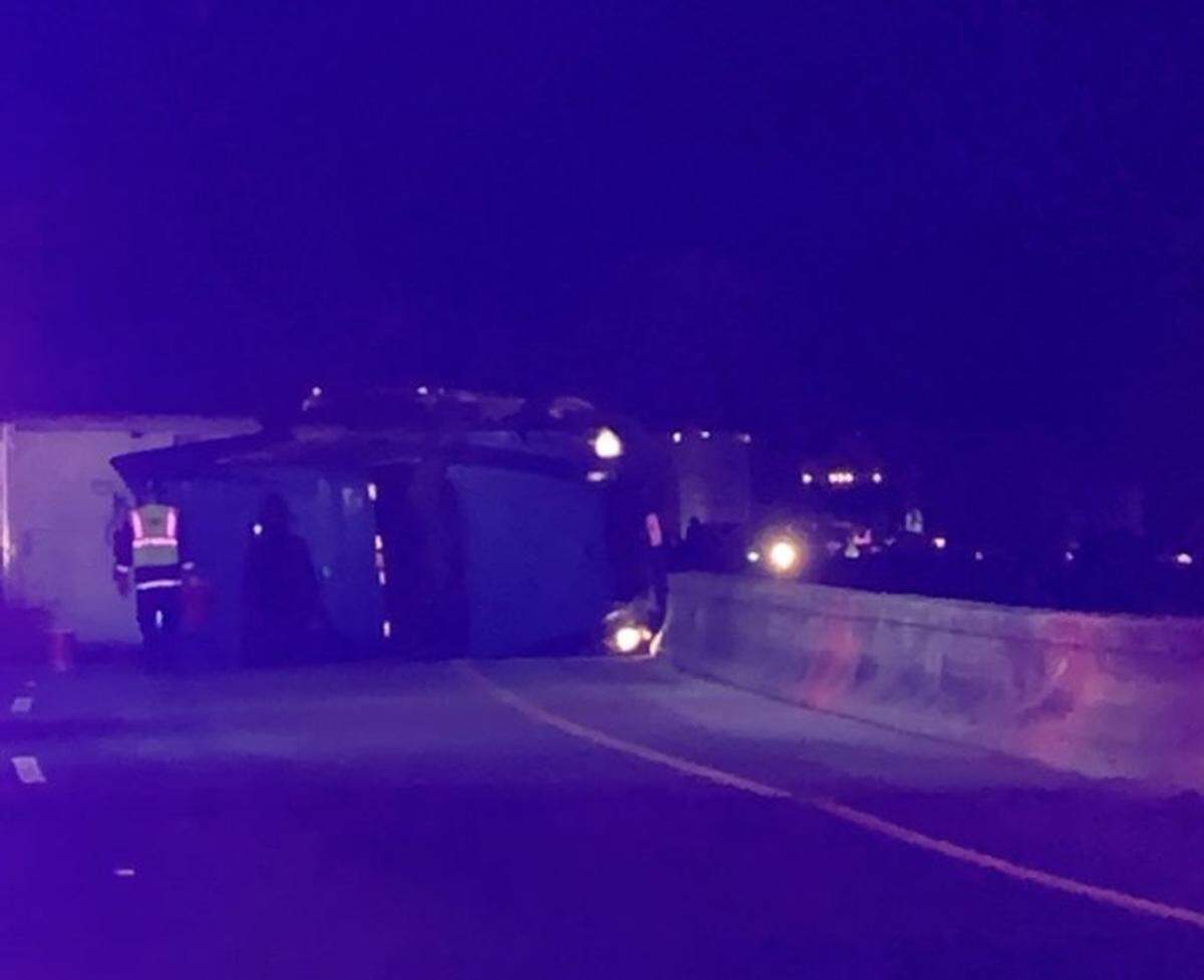 An overturned tractor trailer is blocking traffic on all of the westbound lanes on Interstate 26.