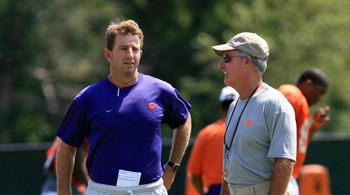 Clemson football assistant coach Dabo Swinney, left, talks with head coach Tommy Bowden during practice Aug. 6, 2008 in Clemson, S.C.. Tommy Bowden is out as Clemson’s football coach. Bowden and the school split Monday Oct. 13, 2008 in the middle of his 10th season. The school appointed receivers coach Dabo Swinney the interim head coach. (AP Photo/Anderson Independent-Mail, Mark Crammer)