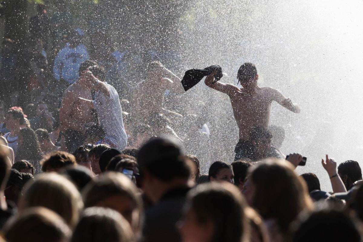 University of South Carolina students celebrate on campus Sunday in the fountain in front of the Thomas Cooper Library after the Gamecocks women’s basketball team’s national championship win over Iowa.