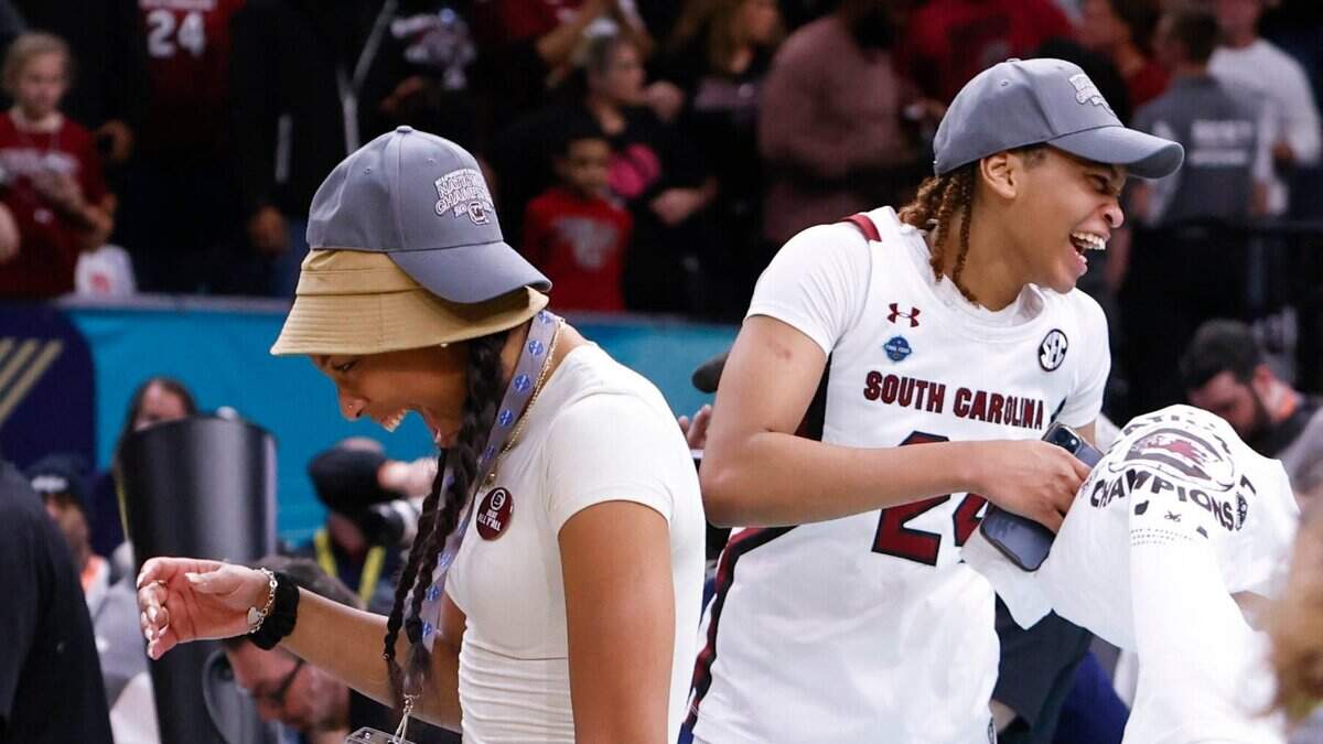 Aja Wilson and LeLe Grissett (24) dance while celebrating the national championship win against UConn at the Target Center in Minneapolis, Minn. on Sunday April 3, 2022.