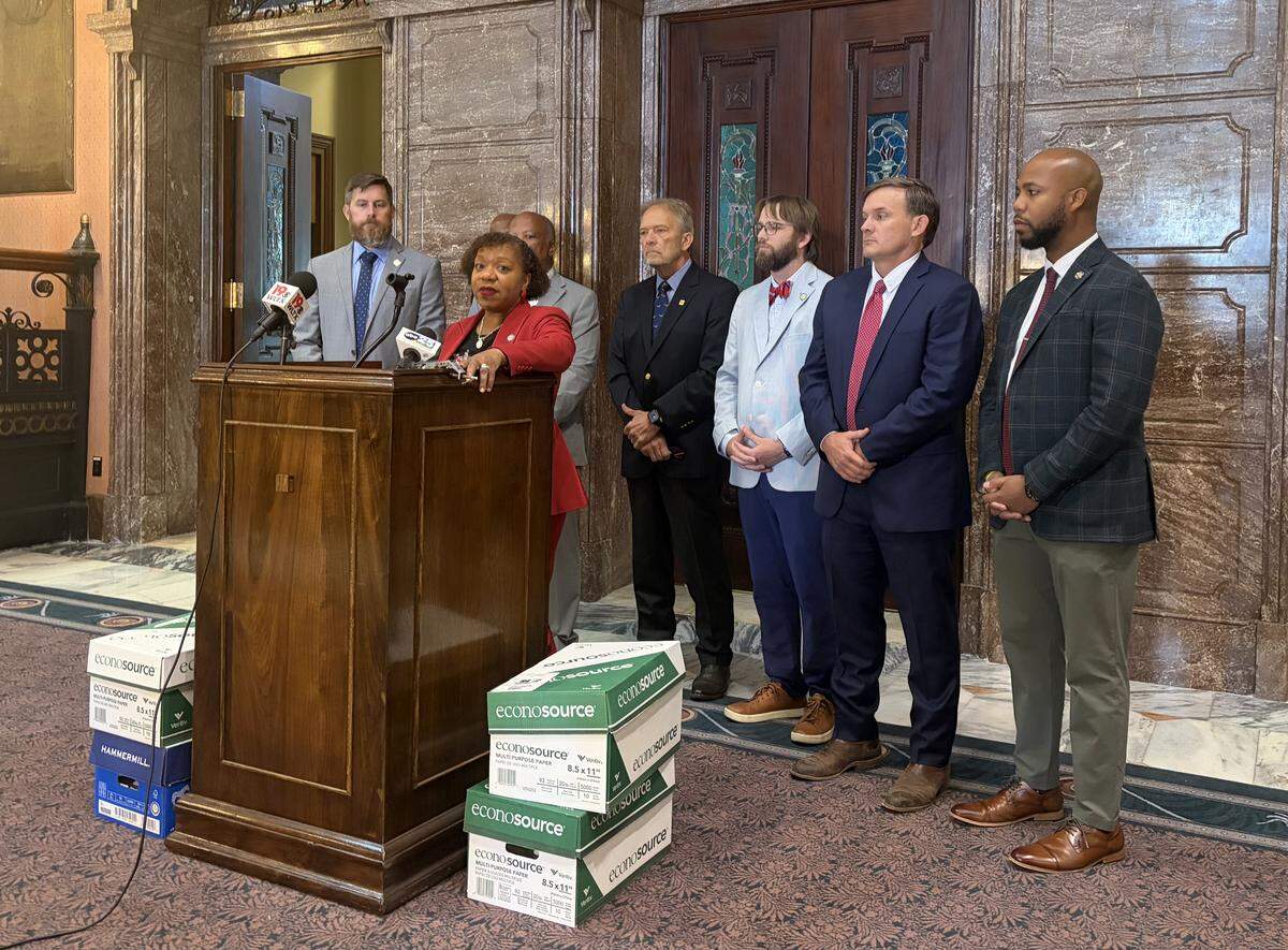 State Sen. Tameika Isaac Devine, D-Richland, speaks against middecade redistricting efforts with boxes of Democrats’ amendments on Thursday, May 21, 2026.