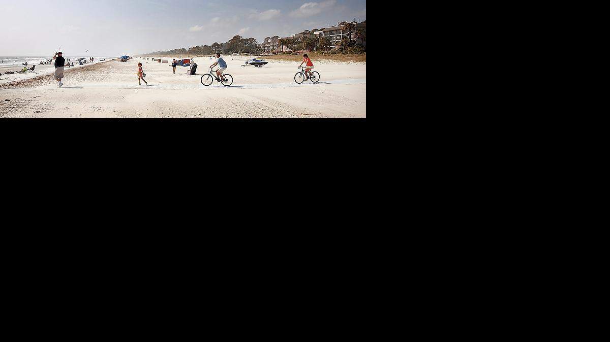 Beach  goers cross the wide buffer to the beach on Hilton Head Island. This is an area that the town put restrictions on the location of the setback, but DHEC wants to move the line toward the beach. Town councilman John Safay is worried about the areas on Hilton Head that aren't protected by the council's restriction. He explains that the decision by DHEC to move building restrictions lines seaward is "exactly the wrong thing to be doing." He said that if it weren't for the beach re-nourishment programs, the beaches would not be near the size they are now.