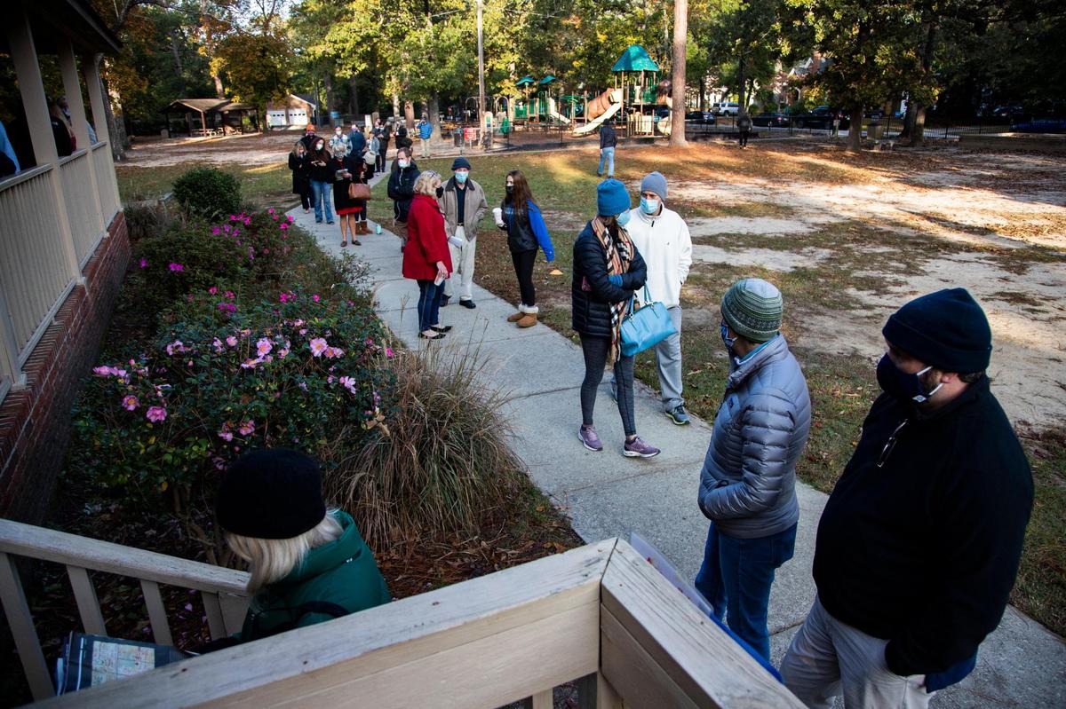 Voters wait outside the Sims Park voting location on Tuesday, November 3, 2020. Voters exiting the polls said they waited in line for less than an hour.