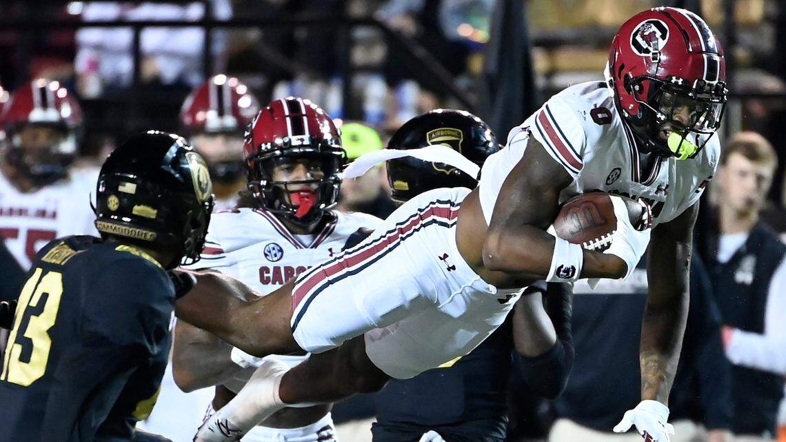 South Carolina running back Jaheim Bell (0) leaps over Vanderbilt defensive back Jaylen Mahoney, bottom center, in the second half of an NCAA college football game Saturday, Nov. 5, 2022, in Nashville, Tenn. (AP Photo/Mark Zaleski)