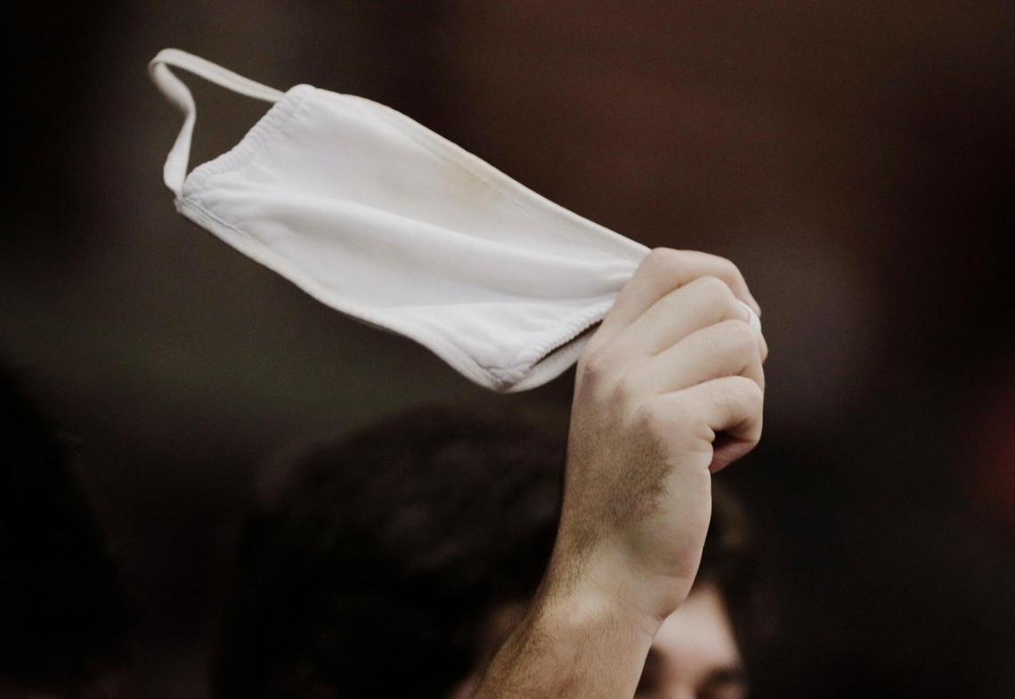 A fan spins his face mask in the air in celebration before the University of South Carolina plays Florida A&M at Colonial Life Arena on January 2, 2021.