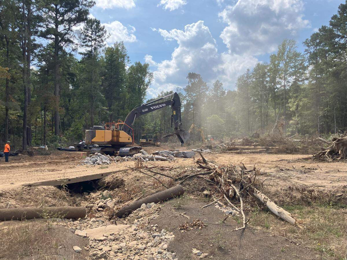 Work crews dig in an area where trees were cleared in the Sumter National Forest of Chester County. The work is being done to improve streams that are clogged with silt. Critics say clearing trees for the project is a bad idea and the cost is too high. The work is being done to offset environmental damage from the Scout Motors site in Richland County. (photo taken Sept. 24, 2025)