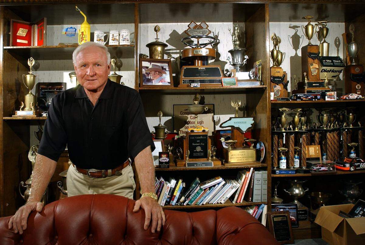 File photo: Legendary NASCAR driver Cale Yarborough in his office at a car dealership he owned in Florence. His office was filled with memorabilia from his driving days.