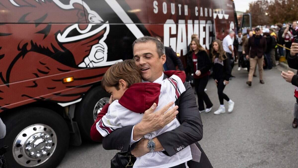 South Carolina Gamecocks head coach Shane Beamer hugs his son Hunter before a Gamecock Walk in 2022.