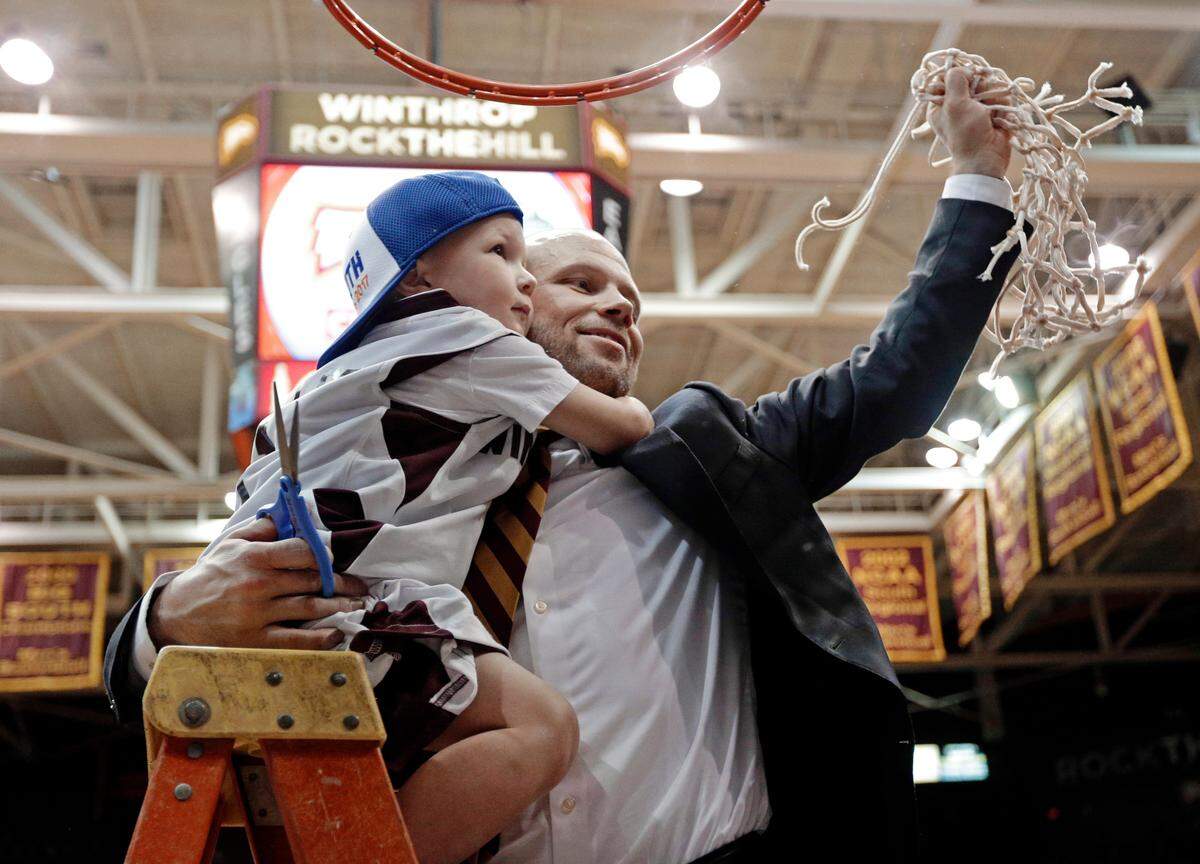 FILE - In this Sunday, March 5, 2017, file photo, Winthrop head coach Pat Kelsey holds his son Johnny as he celebrates cutting down the net after the Big South Conference championship NCAA college basketball game against Campbell in Rock Hill, S.C. (AP Photo/Chuck Burton, File)