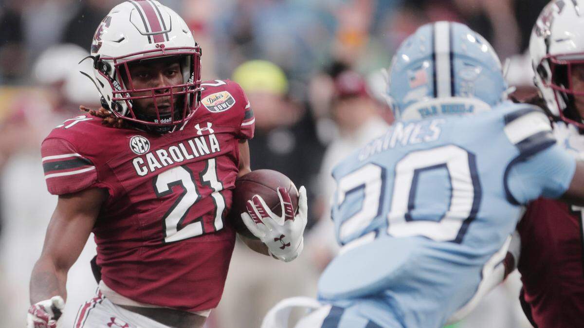 South Carolina Gamecocks running back Juju McDowell (21) runs the ball in the game against North Carolina at the Duke’s Mayo Bowl at Bank of America Stadium in Charlotte, North Carolina on Thursday, December 30, 2021.