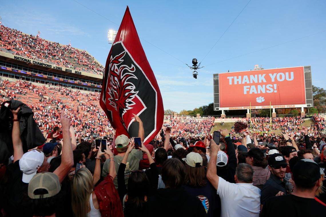 South Carolina Gamecocks head coach Shane Beamer wades through masses of fans after his team beat Clemson on Saturday, November 26, 2022.