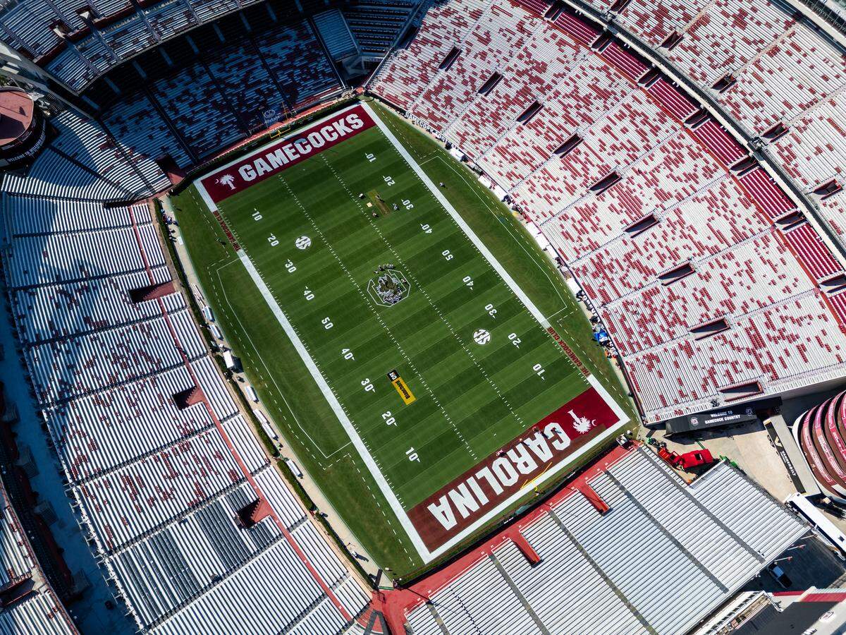 Workers at the University of South Carolina paint the field at Williams-Brice Stadium on Friday, September 12, 2025.