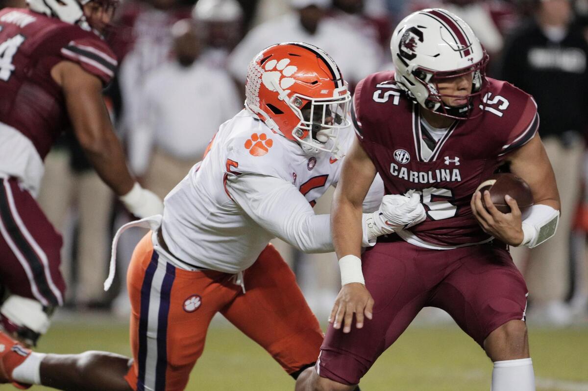 South Carolina Gamecocks quarterback Jason Brown (15) is defended by Clemson’s K.J. Henry (5) at Williams-Brice Stadium on Saturday, November 27, 2021.