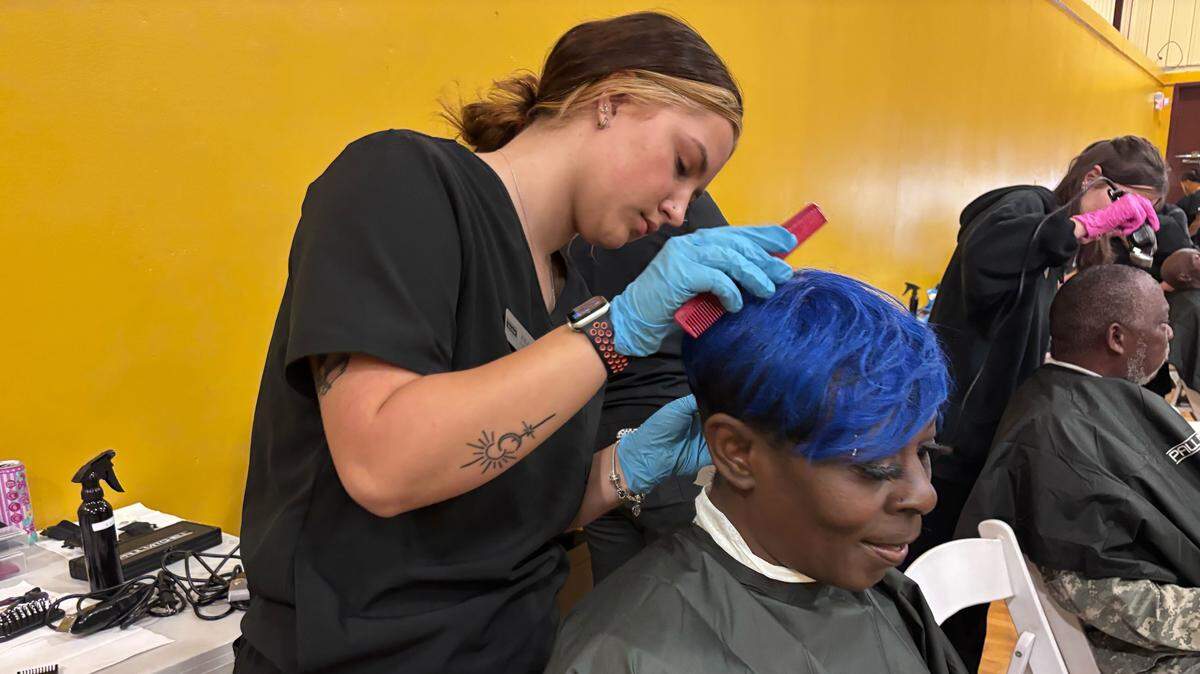Ritalia, 53, sits for a haircut during a City of Columbia World Homeless Day event, held Oct. 10, 2025 at Martin Luther King Jr. Park.