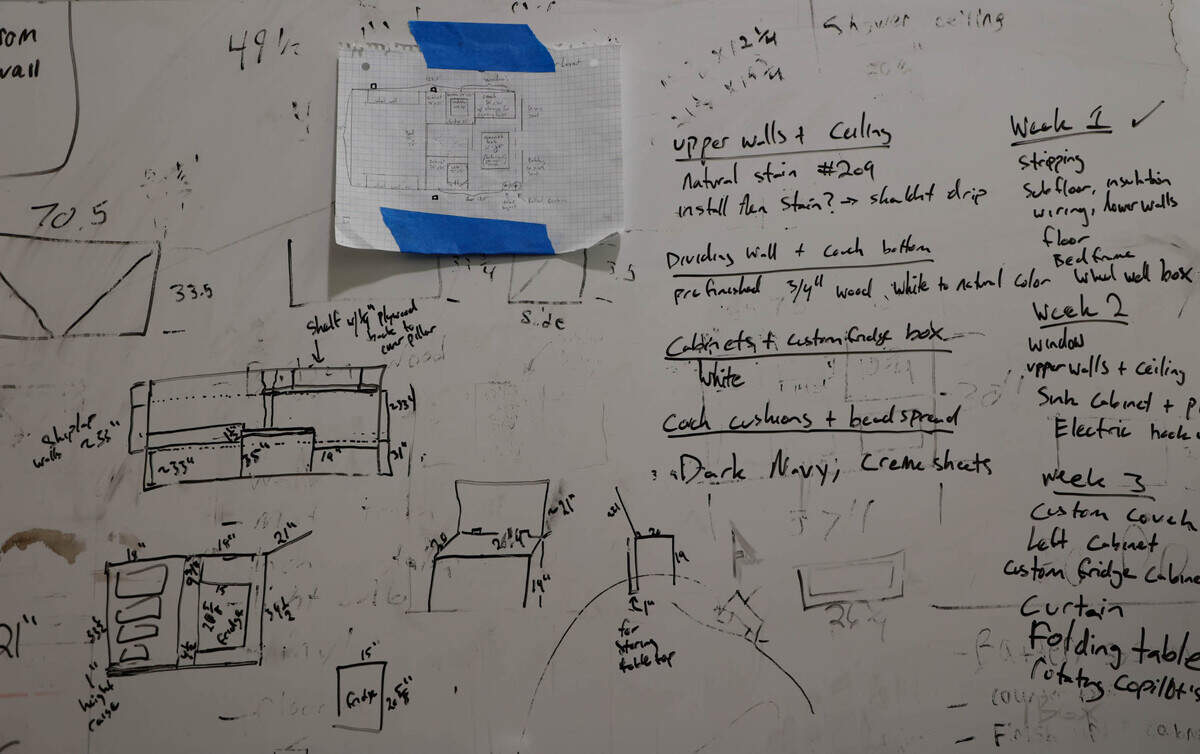 The process for converting cargo vans into living spaces is sketched out on a board in the warehouse where Matthew Alburn converts cargo vans into living spaces.