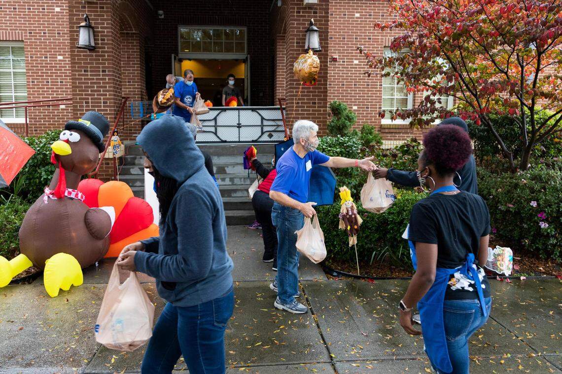 Members of churches across Columbia hand out a Thanksgiving lunch at The Basilica of St. Peter in downtown Columbia, South Carolina on Thursday, November 26, 2020. Volunteers handed out masks and encouraged people to stand apart.