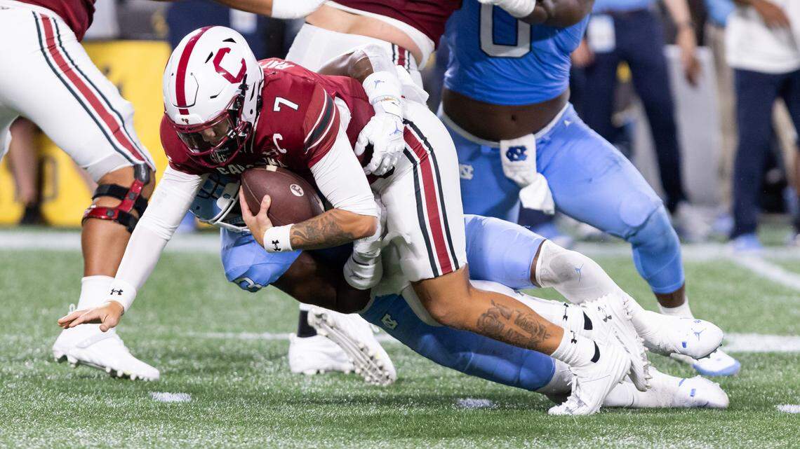 South Carolina quarterback Spencer Rattler (7) gets sacked by North Carolina linebacker Amari Gainer (3) during the Gamecocks’ season opener against North Carolina at Bank of America Stadium in Charlotte on Saturday, September 2, 2023.