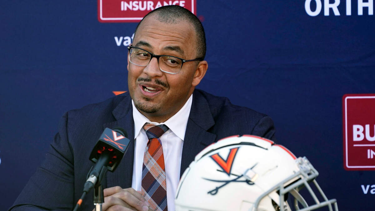 New Virginia head football coach and longtime Clemson assistant coach Tony Elliott speaks during an introductory NCAA college football news conference at the school, Monday, Dec. 13, 2021, in Charlottesville, Va. Elliott will take over the program after the upcoming bowl game. (AP Photo/Steve Helber)